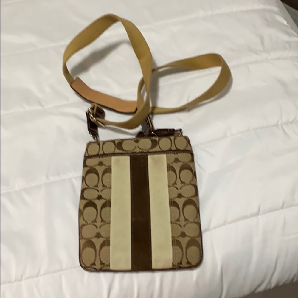 Coach tan crossbody bag with zipper pocket on back